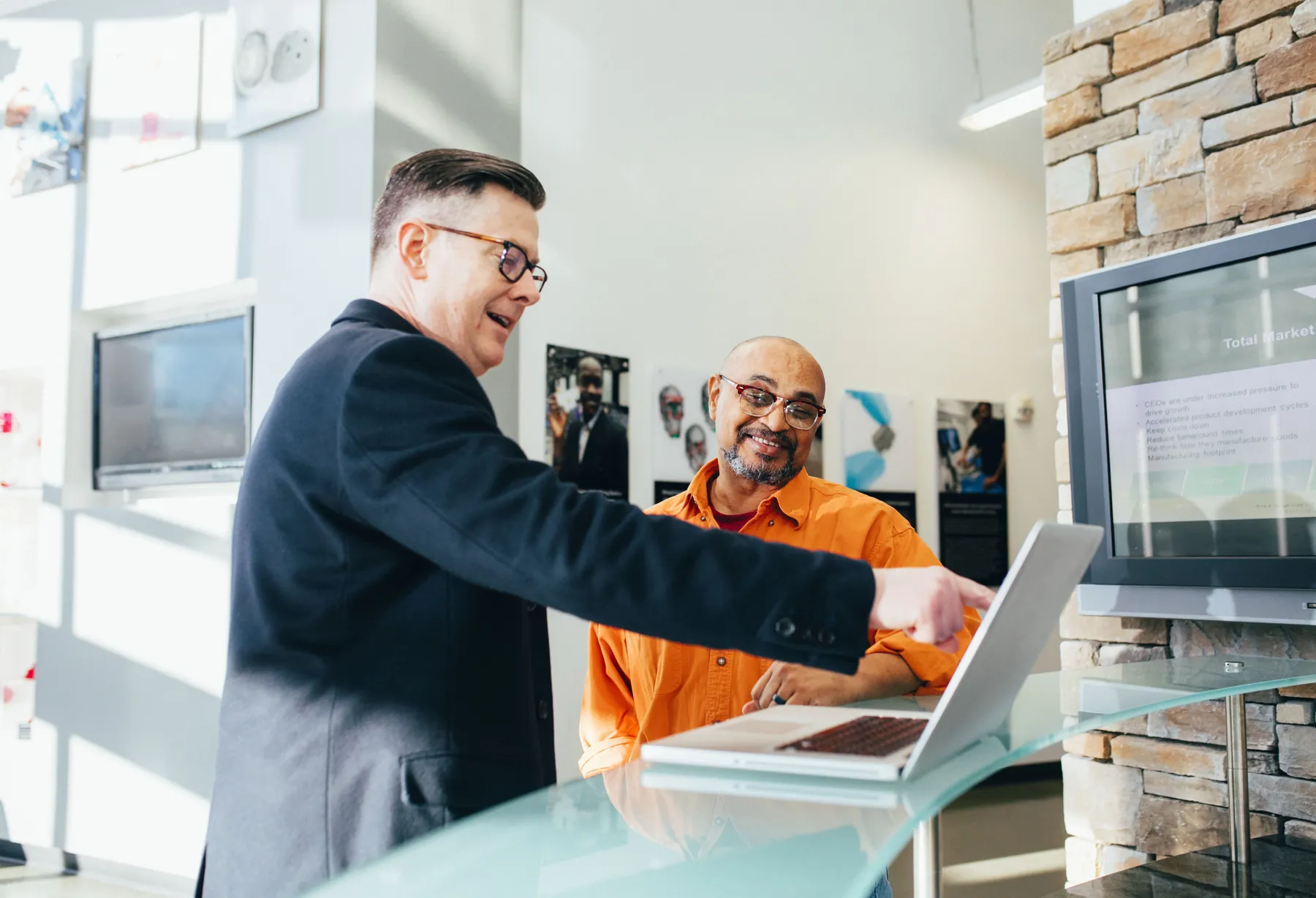 A consultant reviewing figures at a table with a business owner.